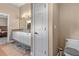 Bathroom featuring double sinks and granite countertops, with an adjoined toilet room and bedroom access at 800 Sterling Chase Dr, Port Orange, FL 32128