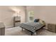 Comfortable bedroom bathed in light, featuring a houndstooth coverlet and views to the lush backyard at 800 Sterling Chase Dr, Port Orange, FL 32128