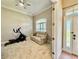 Bonus room featuring a comfortable loveseat, exercise equipment and a window with plantation shutters at 800 Sterling Chase Dr, Port Orange, FL 32128