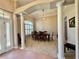 Dining room featuring a decorative light fixture, large windows with shutters, and architectural columns at 800 Sterling Chase Dr, Port Orange, FL 32128