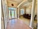 Elegant foyer with tile flooring leading to the dining room, featuring a decorative column and high ceilings at 800 Sterling Chase Dr, Port Orange, FL 32128