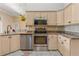 Kitchen with stainless steel appliances, granite countertops, and tiled flooring at 800 Sterling Chase Dr, Port Orange, FL 32128