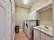 Laundry room with washer, dryer, utility sink, and storage space at 800 Sterling Chase Dr, Port Orange, FL 32128