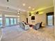 Spacious living room with ample seating, a large ceiling fan, and access to the outdoor area through glass doors at 800 Sterling Chase Dr, Port Orange, FL 32128