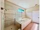 Spa-like bathroom features a glass shower and jacuzzi tub for a relaxing retreat at 800 Sterling Chase Dr, Port Orange, FL 32128