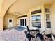 Covered patio with brick flooring, multiple windows, and outdoor seating at 800 Sterling Chase Dr, Port Orange, FL 32128