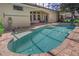 Screened-in pool with rock waterfall feature and covered patio seating at 800 Sterling Chase Dr, Port Orange, FL 32128