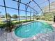 Screened-in pool with lake view, brick patio and mature landscaping at 800 Sterling Chase Dr, Port Orange, FL 32128