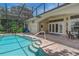Screened-in pool area featuring a pool with a brick surround and a covered patio at 800 Sterling Chase Dr, Port Orange, FL 32128