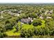 Stunning aerial view of the property with a lake and lush greenery surrounding the home at 8542 Eden Park Rd, Orlando, FL 32810