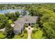 Aerial view of an estate home with well maintained lawn and lush landscaping at 8542 Eden Park Rd, Orlando, FL 32810