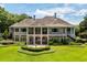 Rear exterior view of home with covered patio and large landscaped backyard at 8542 Eden Park Rd, Orlando, FL 32810