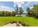 Lush backyard with manicured lawn and views of the lake and fountain at 8542 Eden Park Rd, Orlando, FL 32810