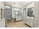 Bright bathroom with double vanities, chandelier lighting, and tile flooring at 8542 Eden Park Rd, Orlando, FL 32810