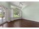Light-filled bedroom with large windows, doors, and views of the grounds at 8542 Eden Park Rd, Orlando, FL 32810