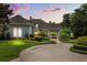 Stately home boasts professional landscaping, brick circular drive and decorative fountain at 8542 Eden Park Rd, Orlando, FL 32810