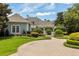 Charming home featuring circular driveway, lush landscaping and decorative fountain at 8542 Eden Park Rd, Orlando, FL 32810