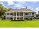Grand home exterior boasting a manicured lawn and impressive columns at 8542 Eden Park Rd, Orlando, FL 32810