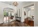 Grand foyer with marble floors, chandelier, and arched doorway leading to living room at 8542 Eden Park Rd, Orlando, FL 32810