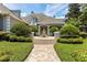 Home's manicured front yard showcases a tiered fountain and brick walkway at 8542 Eden Park Rd, Orlando, FL 32810