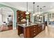 Gourmet kitchen with a large island, stainless steel appliances, and wood cabinets at 8542 Eden Park Rd, Orlando, FL 32810