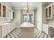 Bright kitchen with a large island, checkered floors, and stainless steel appliances at 8542 Eden Park Rd, Orlando, FL 32810