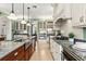 Open kitchen with custom cabinets, stainless steel appliances and a large island with bar seating at 8542 Eden Park Rd, Orlando, FL 32810