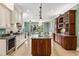 Spacious kitchen with a large island, granite countertops, stainless steel appliances and custom cabinetry at 8542 Eden Park Rd, Orlando, FL 32810