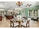 Open floorplan kitchen and dining room with stainless appliances, chandelier, and large island at 8542 Eden Park Rd, Orlando, FL 32810
