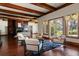 Bright living room with hardwood floors, wood beams, fireplace, and lake views at 8542 Eden Park Rd, Orlando, FL 32810