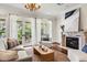 Bright living room with fireplace, hardwood floors, and french doors leading to balcony at 8542 Eden Park Rd, Orlando, FL 32810