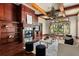 Warm living room features a wood-paneled fireplace, built-in bookshelves, hardwood floors, and a large window at 8542 Eden Park Rd, Orlando, FL 32810