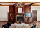 Warm living room features a wood-paneled fireplace, built-in bookshelves, hardwood floors, and a large window at 8542 Eden Park Rd, Orlando, FL 32810