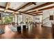 Spacious living room featuring exposed wood beams, large windows, hardwood floors, and an elegant staircase at 8542 Eden Park Rd, Orlando, FL 32810