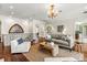 Upstairs living room with hardwood floors, chandelier, and stained glass at 8542 Eden Park Rd, Orlando, FL 32810
