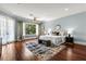 Main bedroom with a king-sized bed, a ceiling fan, hardwood floors, and large windows overlooking a lake at 8542 Eden Park Rd, Orlando, FL 32810