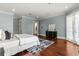 Tranquil main bedroom featuring hardwood floors, a large window, and a decorative rug at 8542 Eden Park Rd, Orlando, FL 32810