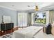 Main bedroom suite boasts hardwood floors, water view, lots of natural light and ceiling fan at 8542 Eden Park Rd, Orlando, FL 32810