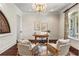 Bright office features hardwood floors, a stained glass window, and two comfortable chairs at 8542 Eden Park Rd, Orlando, FL 32810