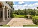 Spacious travertine patio with a fountain overlooking the backyard landscaping at 8542 Eden Park Rd, Orlando, FL 32810