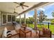 Covered patio with comfortable seating and stunning lake view at 8542 Eden Park Rd, Orlando, FL 32810