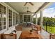Relaxing covered porch featuring ample seating and ceiling fans at 8542 Eden Park Rd, Orlando, FL 32810