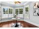 Sun-filled sitting room with hardwood floors, large windows, and stylish decor at 8542 Eden Park Rd, Orlando, FL 32810
