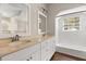 Bathroom with double vanity, quartz countertop, and a tub with shower at 8800 Torey Pines Ter, Orlando, FL 32819
