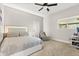The serene bedroom is carpeted, has a ceiling fan and includes a light-up headboard for a calming ambiance at 8800 Torey Pines Ter, Orlando, FL 32819