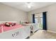 Bedroom with twin beds, carpeting, and access to the backyard at 8800 Torey Pines Ter, Orlando, FL 32819