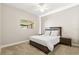 Comfortable bedroom with carpet flooring, ceiling fan, and modern furniture at 8800 Torey Pines Ter, Orlando, FL 32819