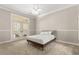 Bright bedroom with neutral tones, carpet flooring, ceiling fan, and private access to a balcony at 8800 Torey Pines Ter, Orlando, FL 32819