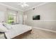 Bedroom with a cozy window seat, plush carpet, and a mounted television for relaxation at 8800 Torey Pines Ter, Orlando, FL 32819