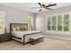 Serene bedroom featuring a large bed, side tables, and shutters on large windows at 8800 Torey Pines Ter, Orlando, FL 32819